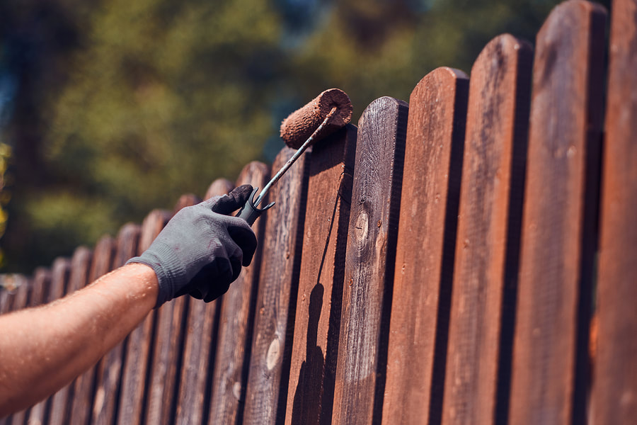 professional painter working on fence painting 